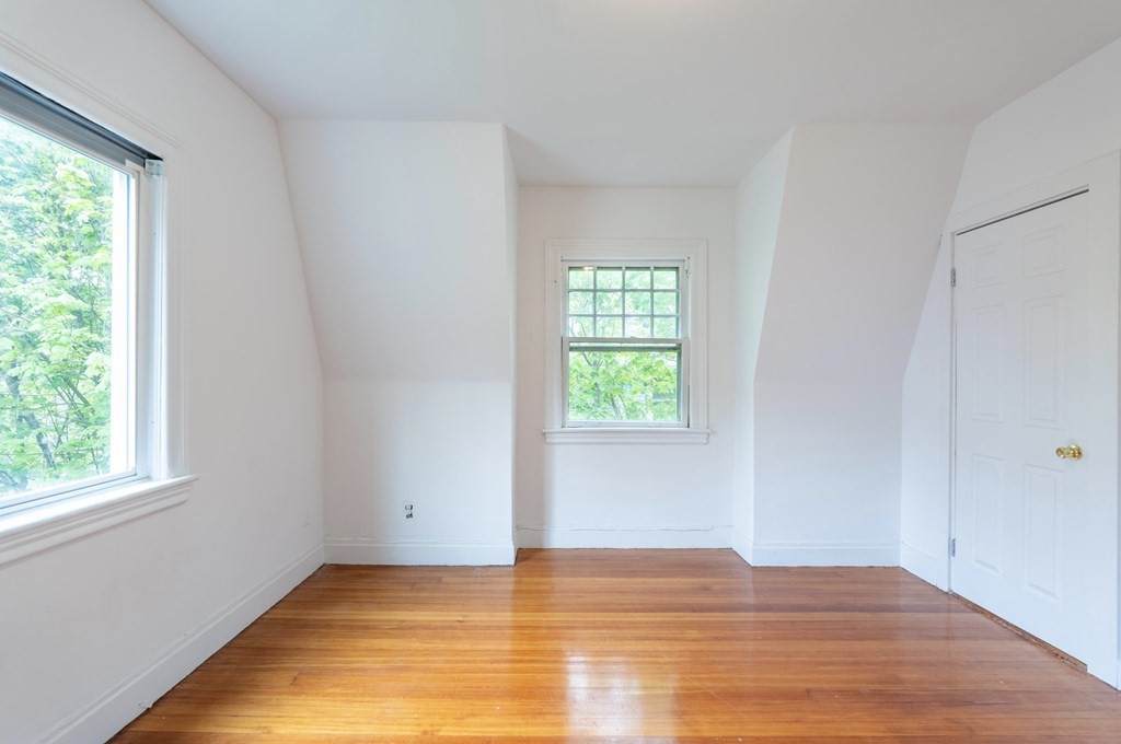 85 Naples Road Brookline, MA 02446 - Photo 10 of 19 a view of an empty room with wooden floor and a window