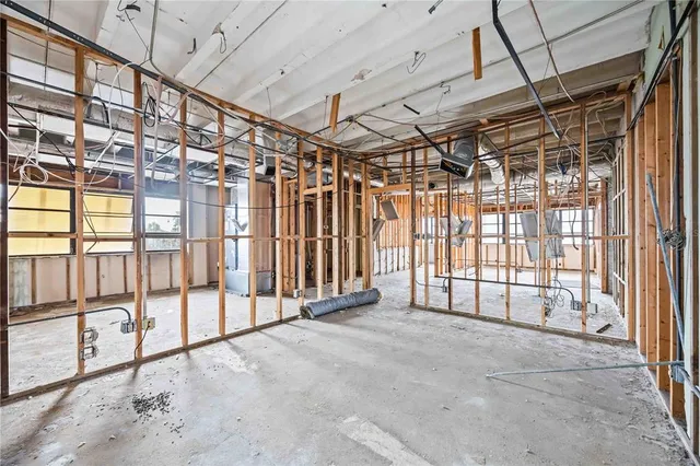 a view of an empty room with a ceiling fan