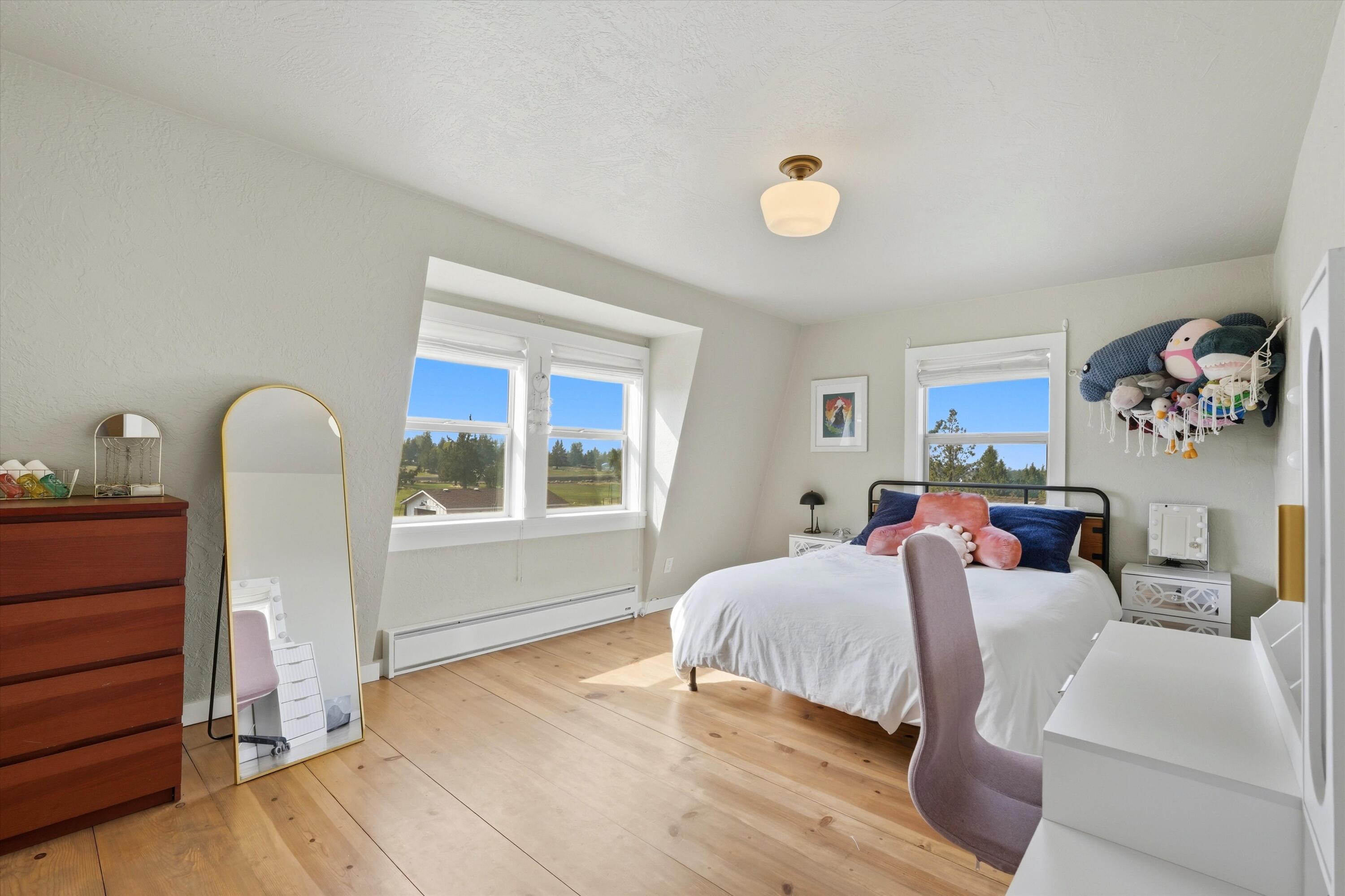 61280 Larsen Road Bend, OR 97702 - Photo 23 of 58 a bedroom with a bed and a window