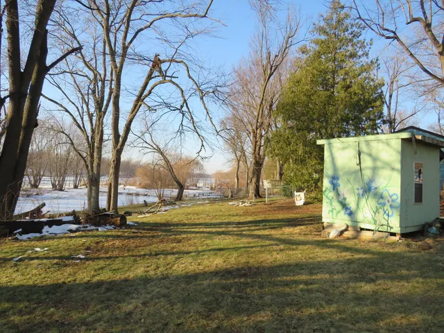 a front view of a house with yard and trees