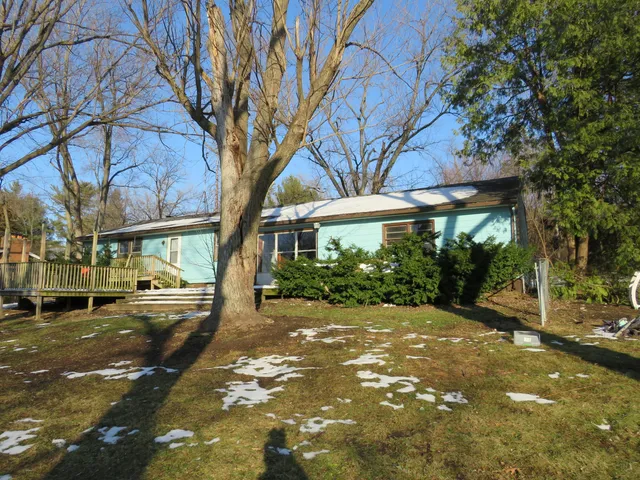 a view of a street with a building and large trees