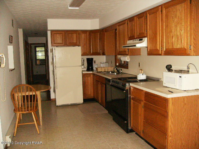 826 Hampstead Road Bushkill, PA 18324 - Photo 2 of 18 a kitchen with a sink a stove and a refrigerator