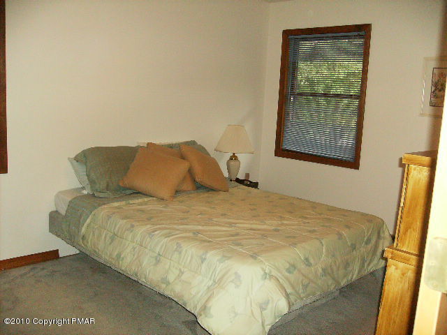 826 Hampstead Road Bushkill, PA 18324 - Photo 9 of 18 a bed sitting in a bedroom next to a window