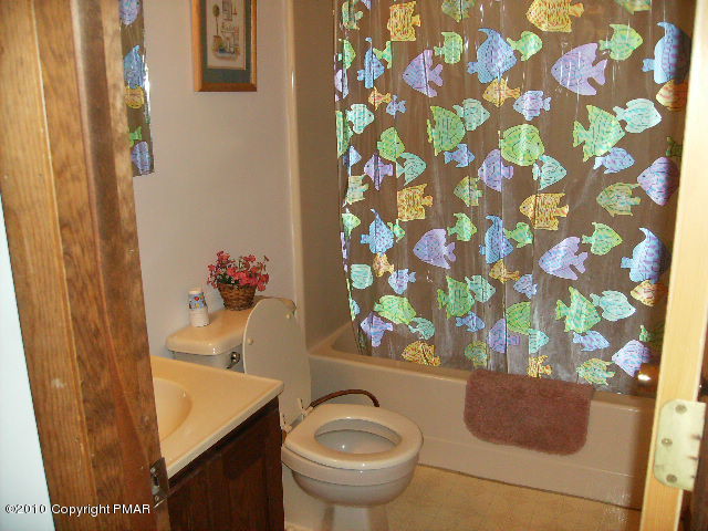 826 Hampstead Road Bushkill, PA 18324 - Photo 10 of 18 a bathroom with a sink toilet and mirror