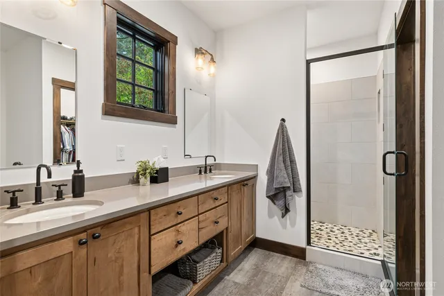 a bathroom with a double vanity sink and mirror