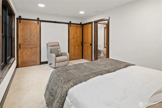 a bedroom with a large bed and a large window