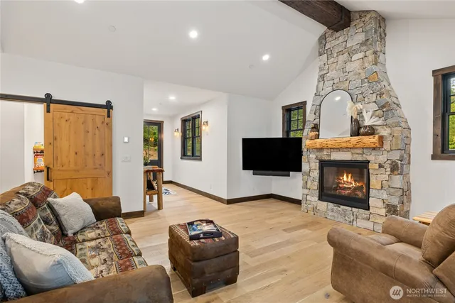 a living room with furniture a fireplace and a flat screen tv