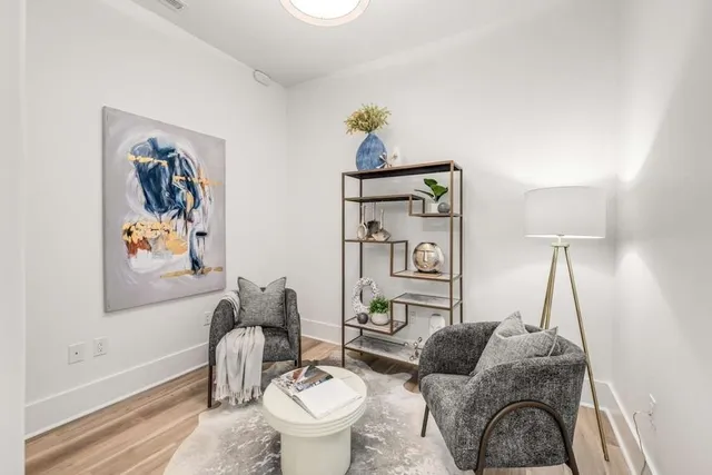 a living room with furniture and a painting