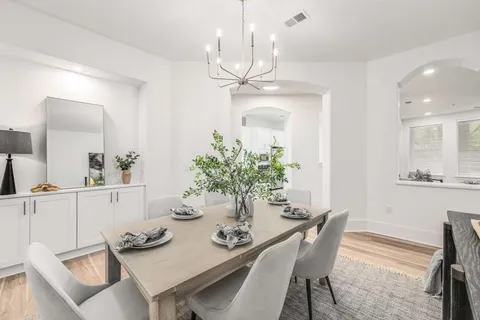 a view of a dining room with furniture and chandelier