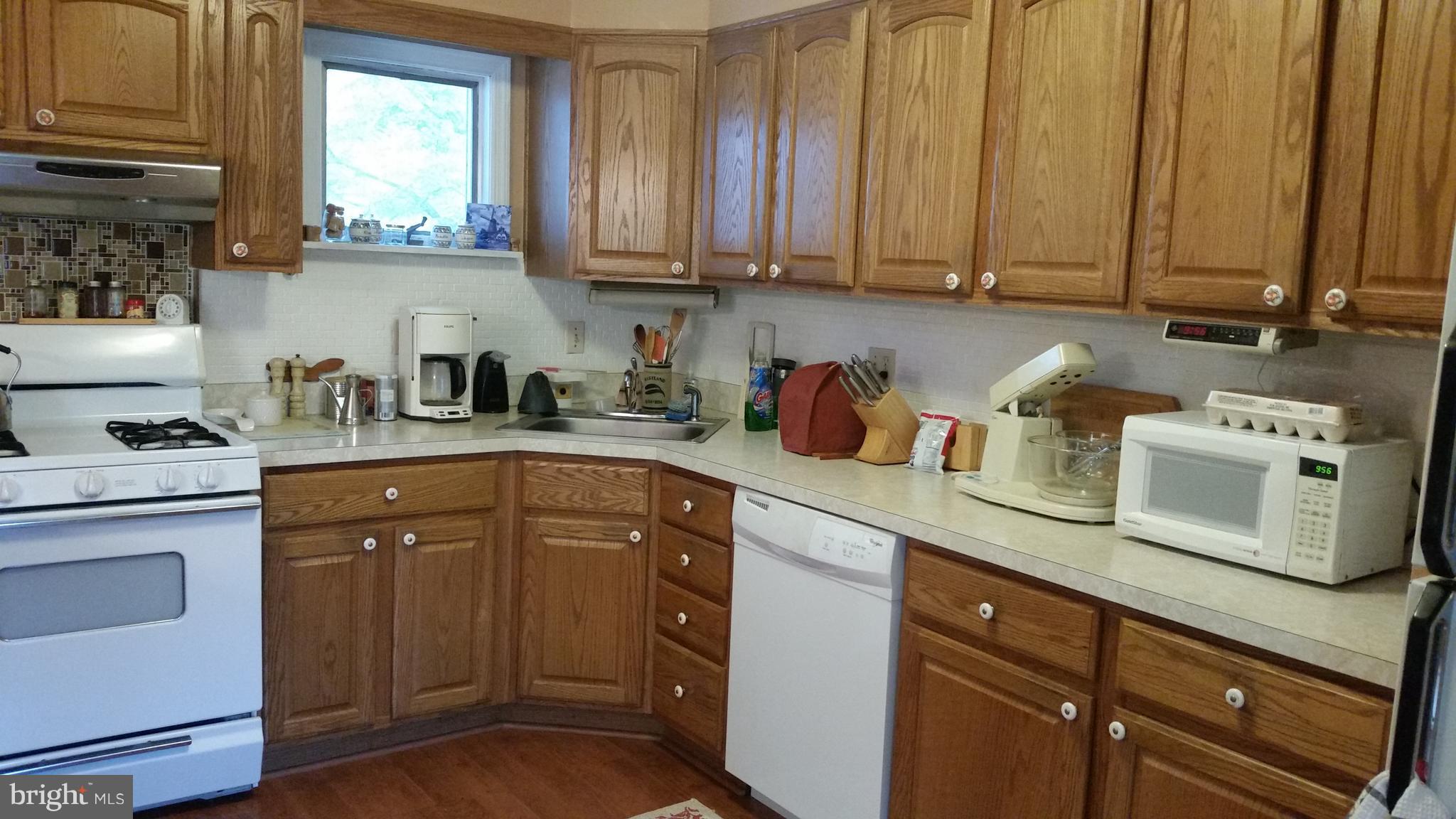 1305 4th Road Baltimore, MD 21220 - Photo 2 of 24 a kitchen with stainless steel appliances granite countertop a sink a stove and cabinets