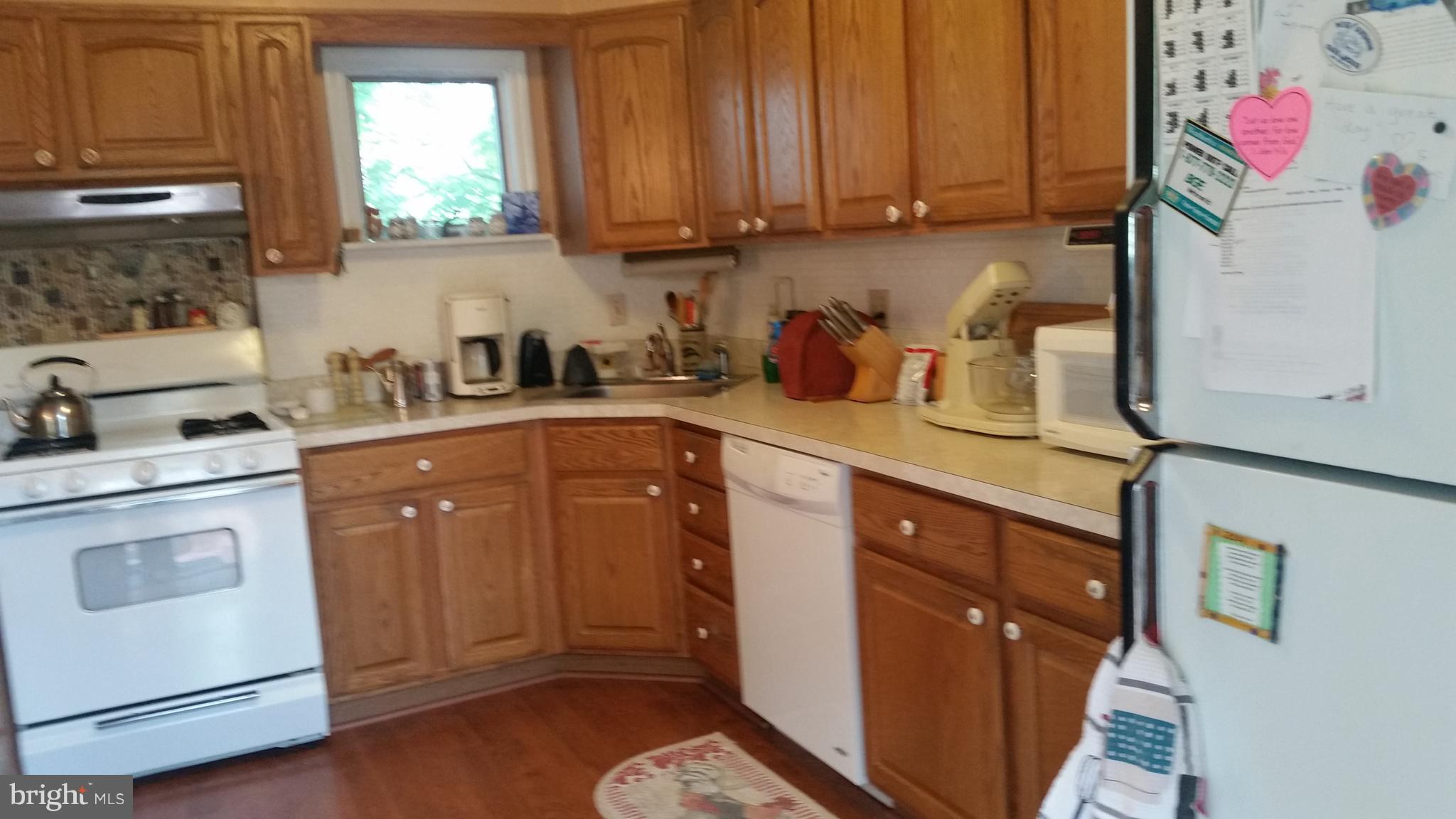 1305 4th Road Baltimore, MD 21220 - Photo 3 of 24 a kitchen with sink cabinets and window