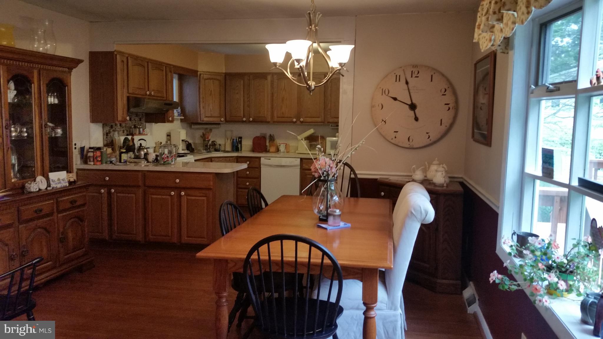 1305 4th Road Baltimore, MD 21220 - Photo 4 of 24 a view of a dining room with furniture window and wooden floor