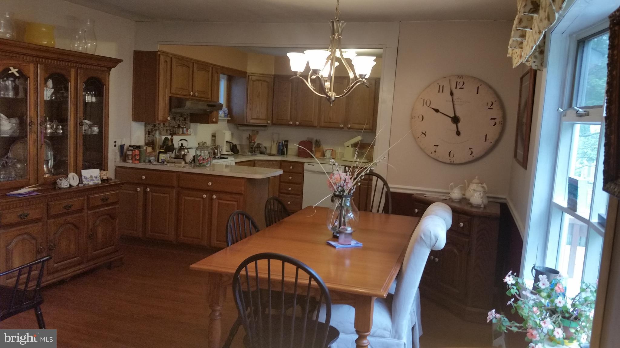 1305 4th Road Baltimore, MD 21220 - Photo 5 of 24 a view of a dining room with furniture and chandelier