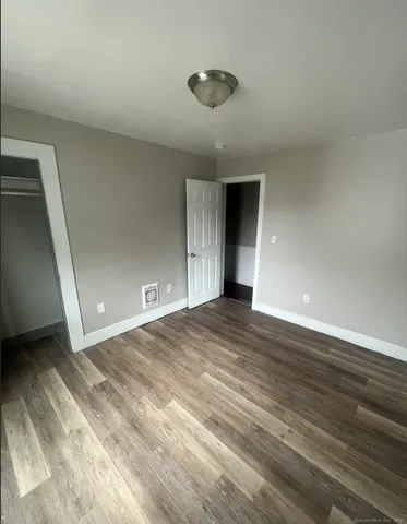 a view of an empty room and wooden floor