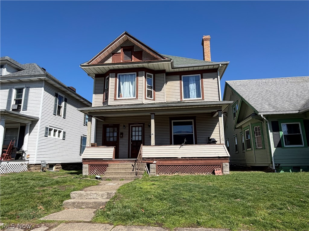436 Locust Street Coshocton, OH 43812 - Photo 1 of 17 View of front of home with a chimney, a front yard, and covered porch