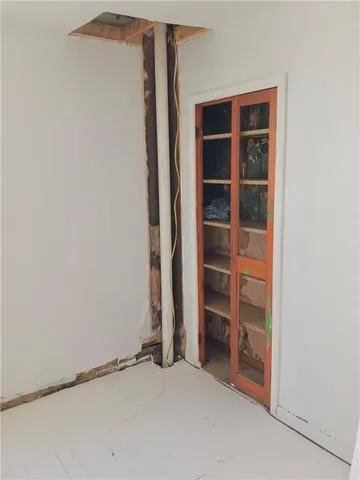 a view of an empty room with a empty space and a window