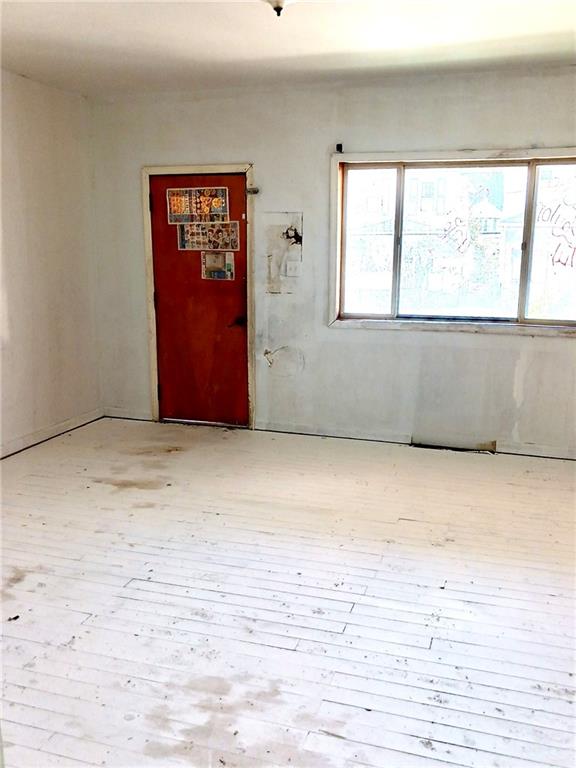 633 5th Avenue Ford City, PA 16226 - Photo 3 of 18 a view of an empty room with wooden floor and a window