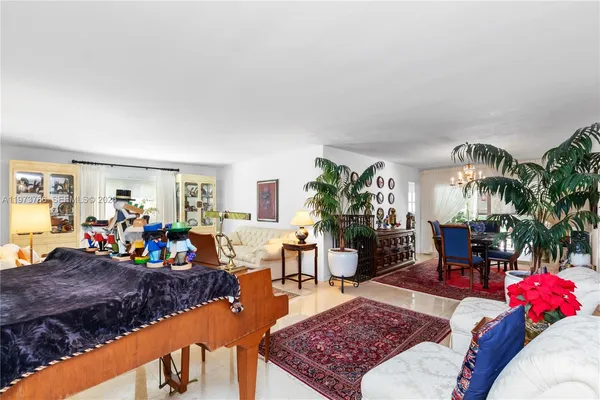 a living room with furniture a rug and a table