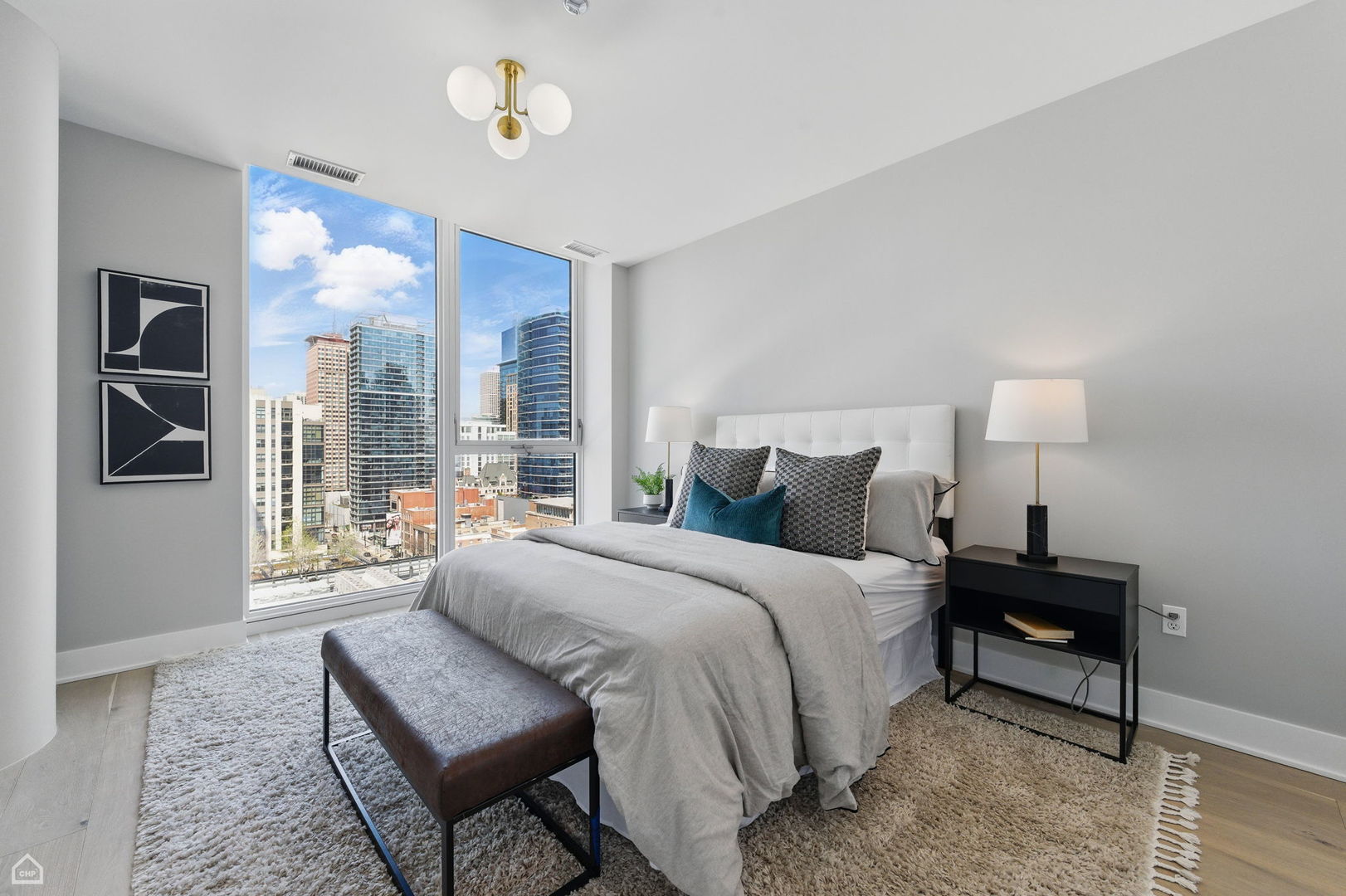 146 West Erie Street, Unit 702 Chicago, IL 60654 - Photo 12 of 17 a bedroom with a bed and wooden floor