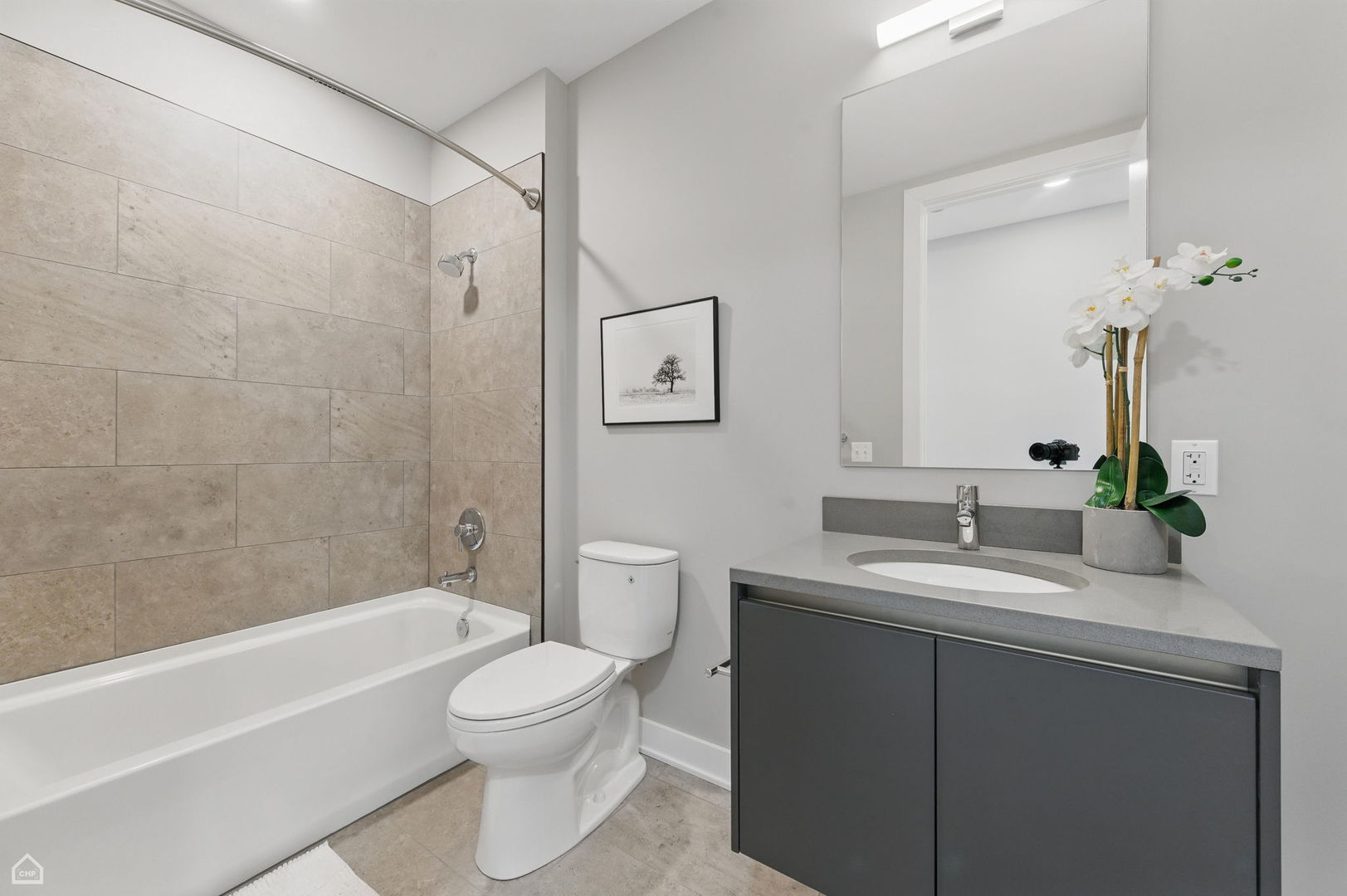 146 West Erie Street, Unit 702 Chicago, IL 60654 - Photo 13 of 17 a bathroom with a toilet a sink a mirror a bathtub and vanity