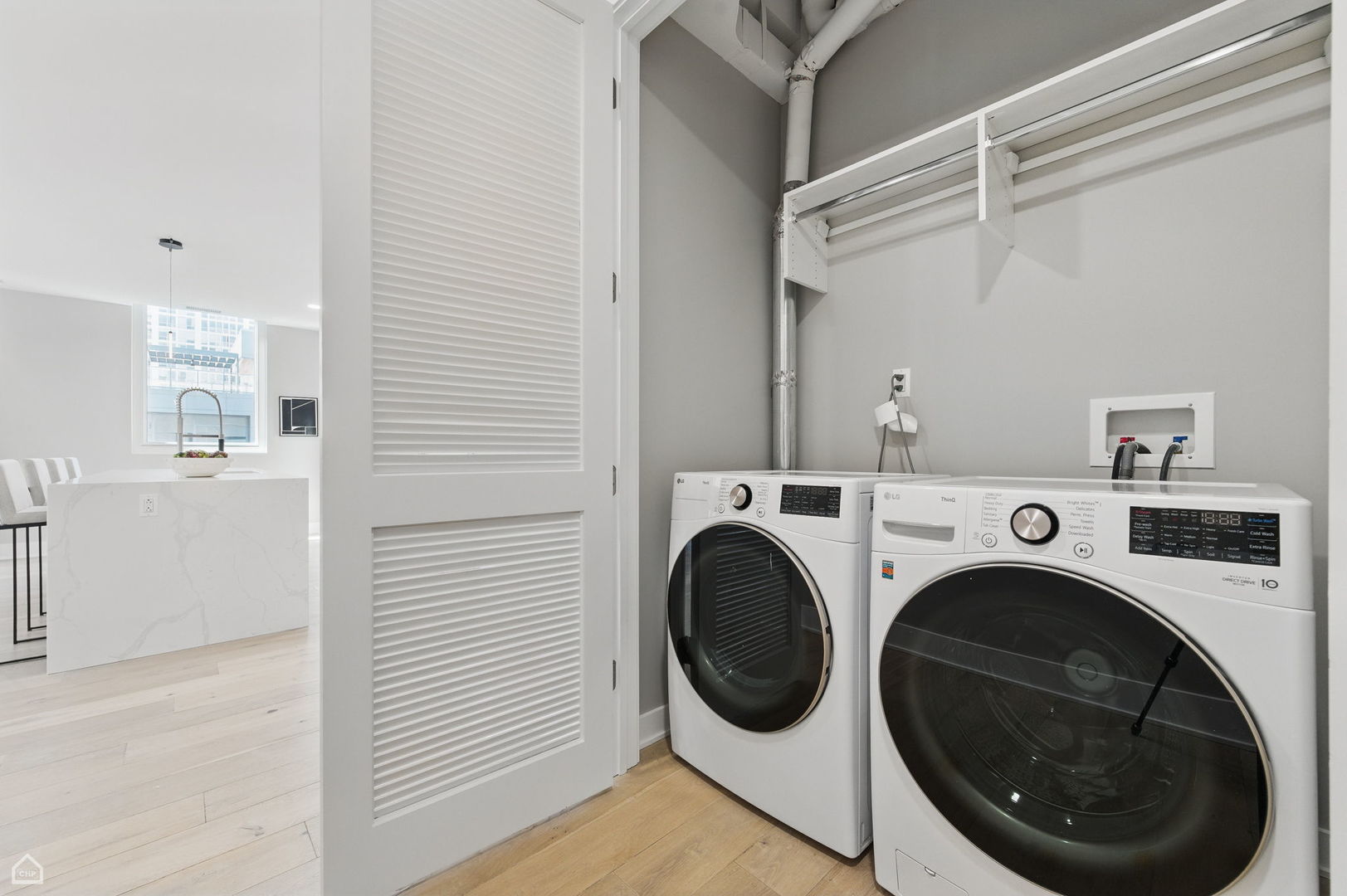 146 West Erie Street, Unit 702 Chicago, IL 60654 - Photo 16 of 17 a view of a hallway with washer and dryer