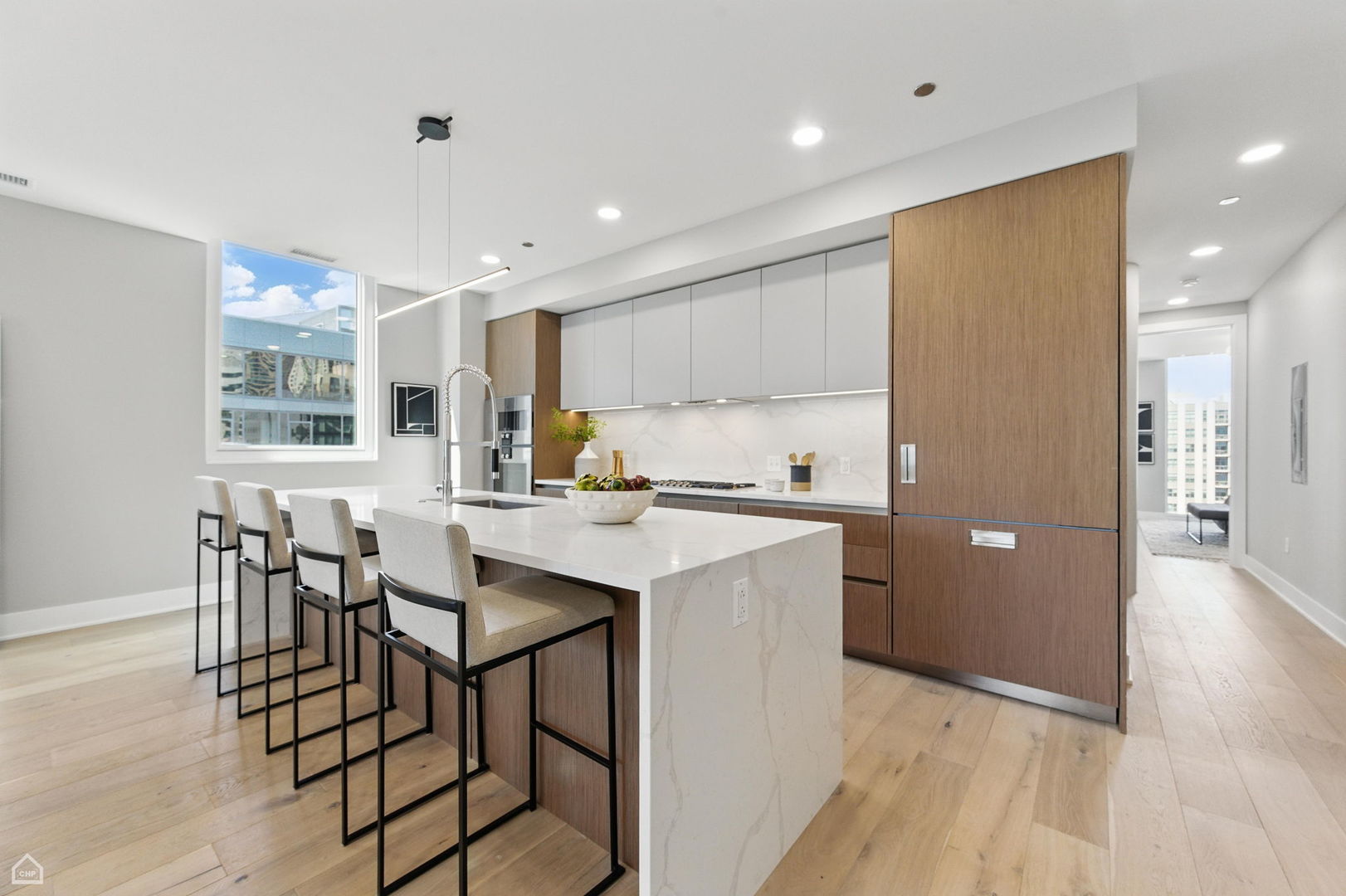 146 West Erie Street, Unit 702 Chicago, IL 60654 - Photo 2 of 17 a kitchen with stainless steel appliances kitchen island granite countertop a sink and cabinets