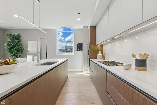 a kitchen with stainless steel appliances a sink and a stove