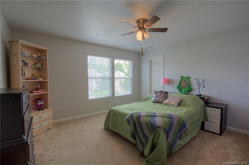 2013 Durand Road Fort Mill, SC 29715 - Photo 14 of 24 a bedroom with a bed and a chandelier