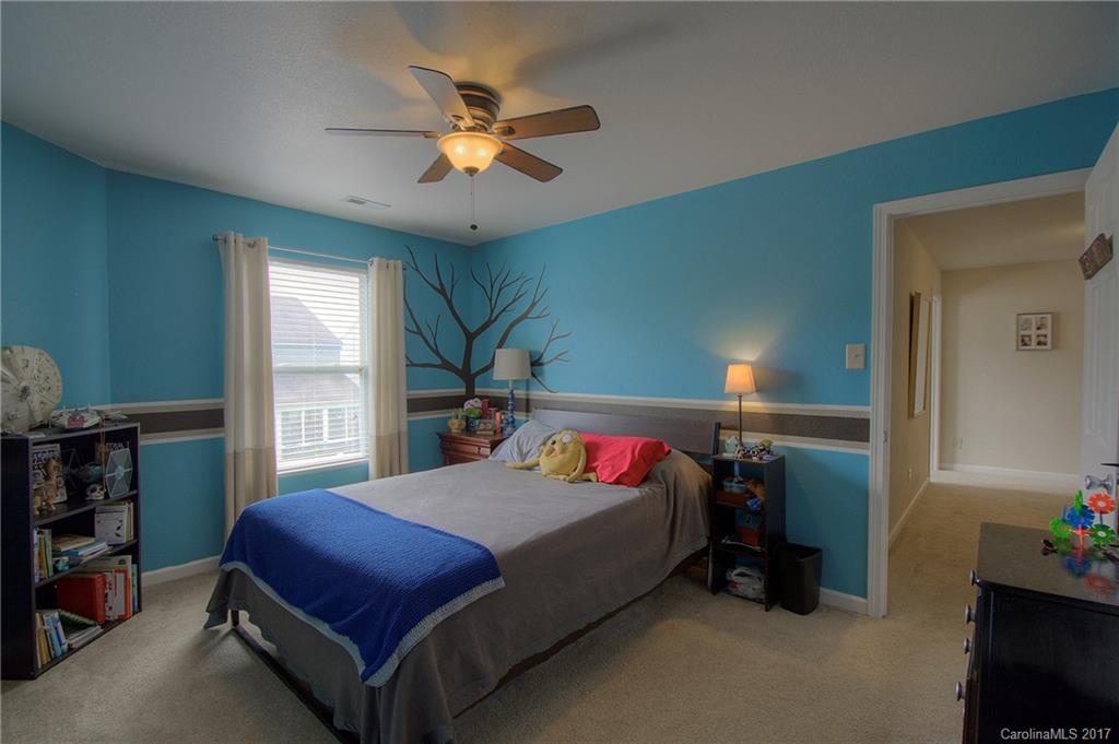 2013 Durand Road Fort Mill, SC 29715 - Photo 16 of 24 a bedroom with a bed and a chandelier