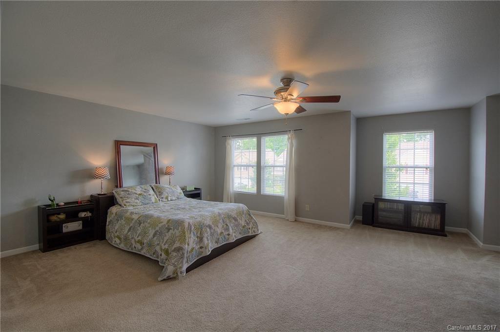 2013 Durand Road Fort Mill, SC 29715 - Photo 18 of 24 a spacious bedroom with a bed and a chandelier