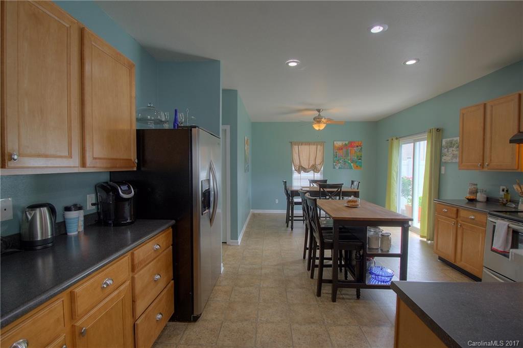 2013 Durand Road Fort Mill, SC 29715 - Photo 10 of 24 a kitchen with stainless steel appliances granite countertop table chairs refrigerator and stove