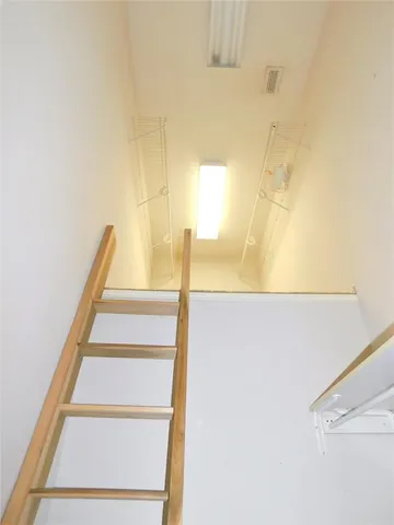 a view of staircase with white walls