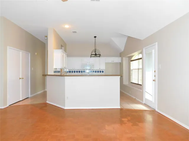 a view of a kitchen with a sink and a window