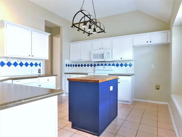 a kitchen with stainless steel appliances a sink and a refrigerator