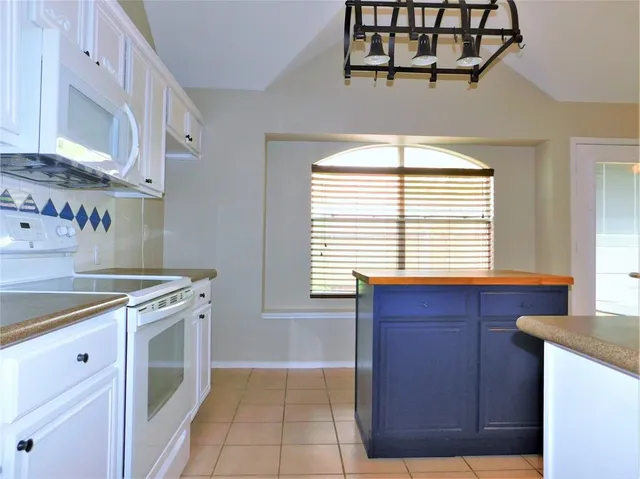 a kitchen with a cabinets and a stove