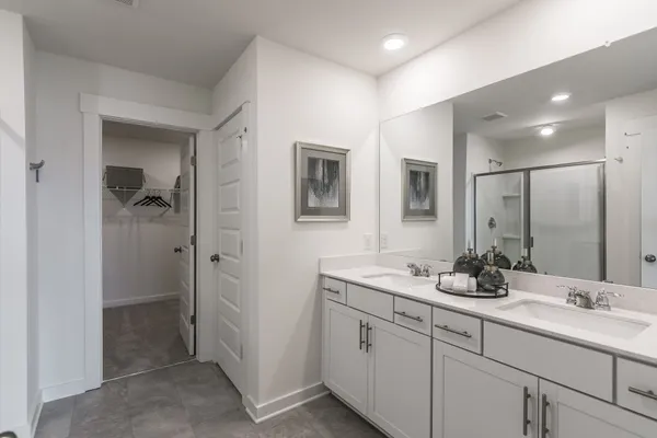 a bathroom with double sink and a mirror