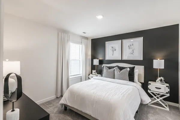 a bedroom with a bed and window