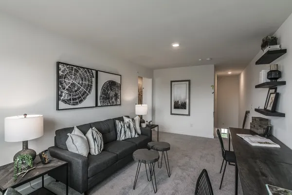 a living room with furniture and a lamp