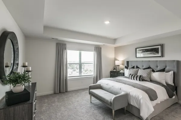 a bedroom with a bed and a couch