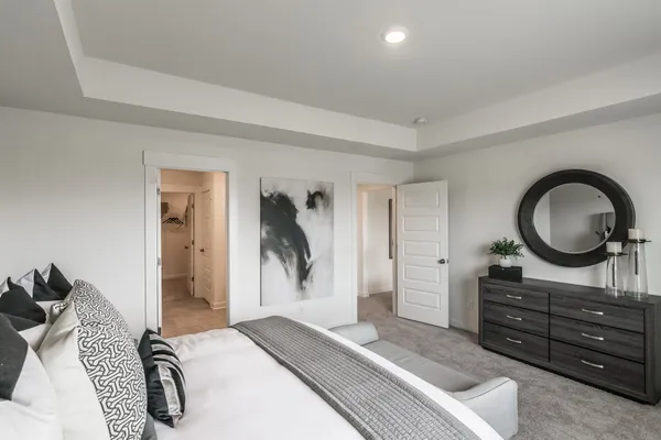 a bedroom with a bed and a dresser
