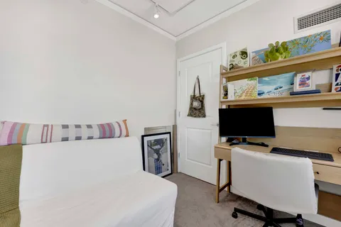 a bedroom with a workspace