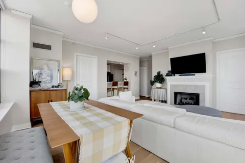 a living room with fireplace furniture and a flat screen tv