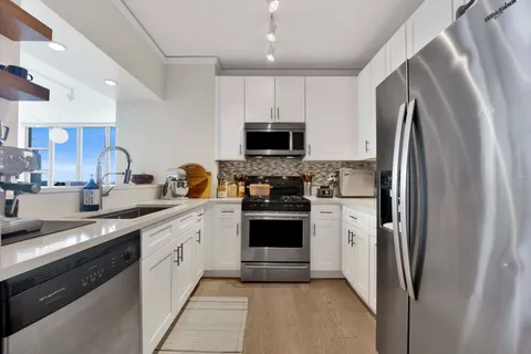 a kitchen with a refrigerator sink and microwave
