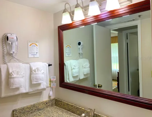 a white toilet sitting next to a white sink
