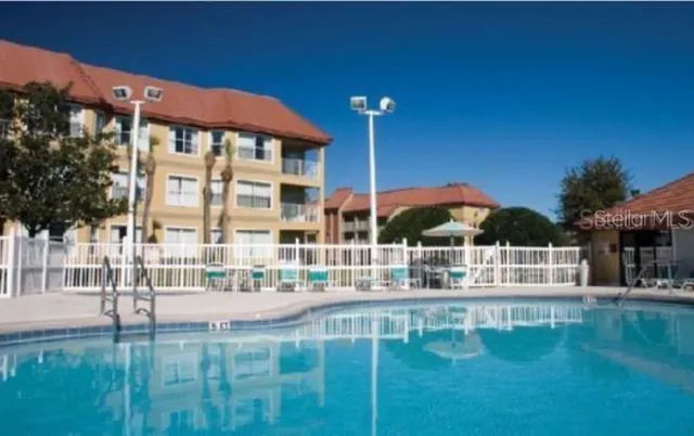 a swimming pool with outdoor seating and yard