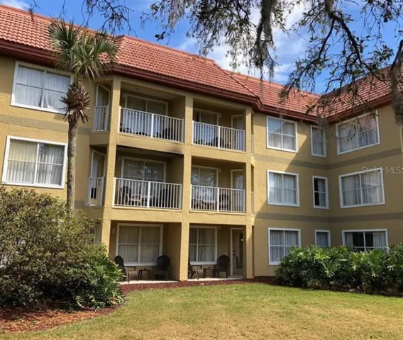 a front view of a residential apartment building with a yard
