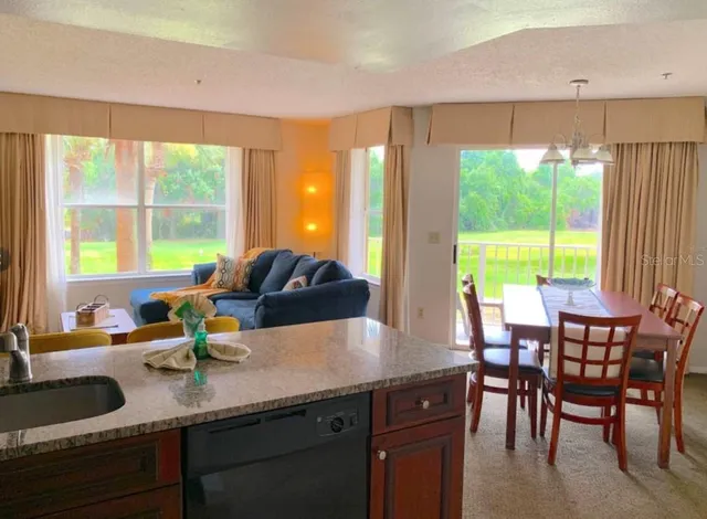 a kitchen with a large window and dining table