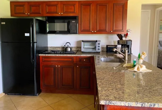 a kitchen with stainless steel appliances granite countertop a stove and cabinets