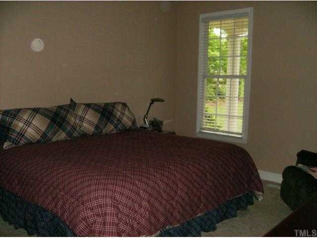 340 Oaks Lane Road Timberlake, NC 27583 - Photo 9 of 9 a bed sitting in a bedroom next to a window