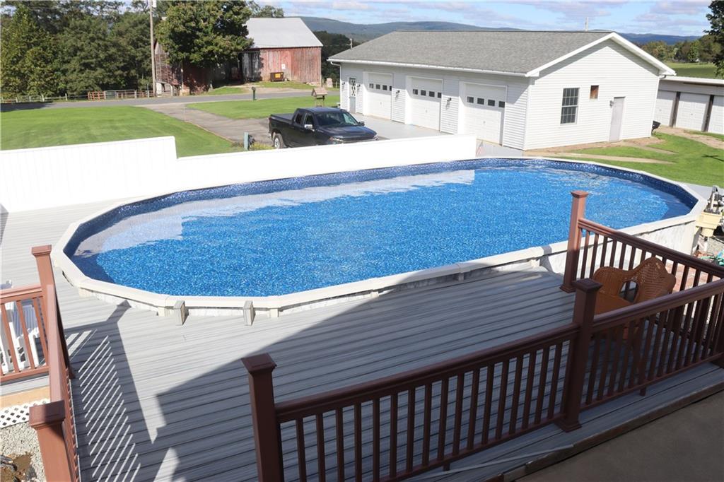View of swimming pool from front roofed deck